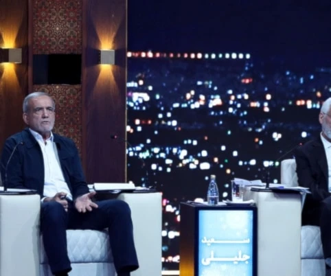 Masoud Pezeshkian, center, speaks in a debate of the candidates as Saeed Jalili listens at the TV studio in Tehran, Iran, Monday, June 17, 2024. (Morteza Fakhri Nezhad/IRIB via AP)