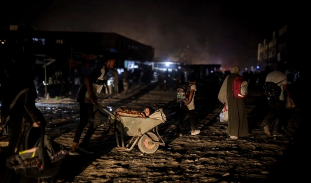 Palestinians displaced by the Israeli genocidal war on the Gaza Strip flee from parts of Khan Younis following an evacuation orders on Monday, July 1, 2024. (AP)